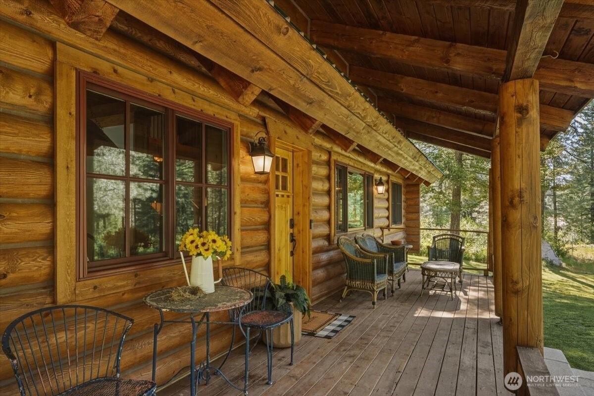 2250 First Crk Road Chelan, WA 98816 - Photo 16 of 39 a view of a patio with table and chairs and wooden floor