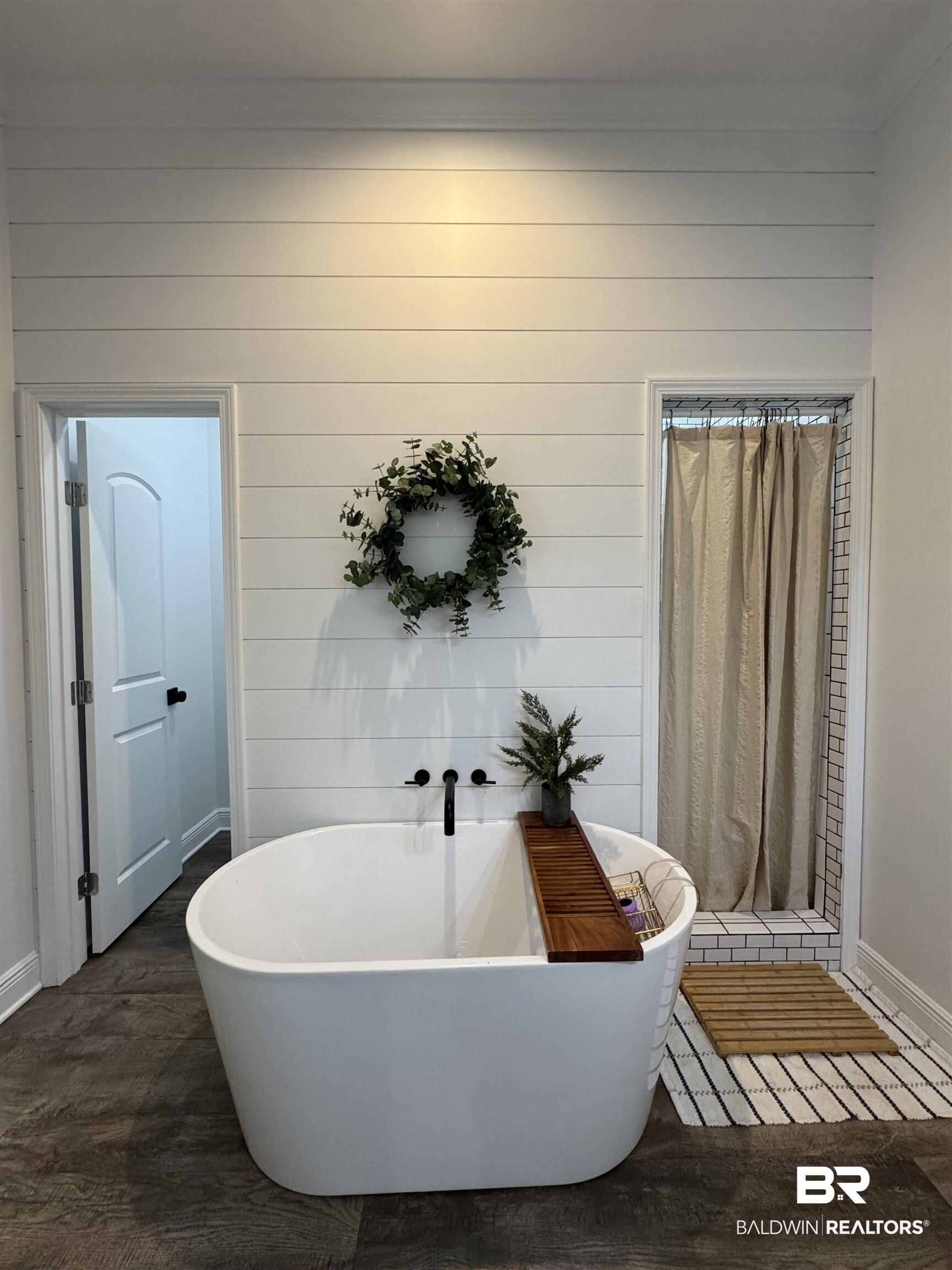 370 Dianne Road Frisco City, AL 36445 - Photo 33 of 41 Bathroom with wood walls, wood-type flooring, and a washtub