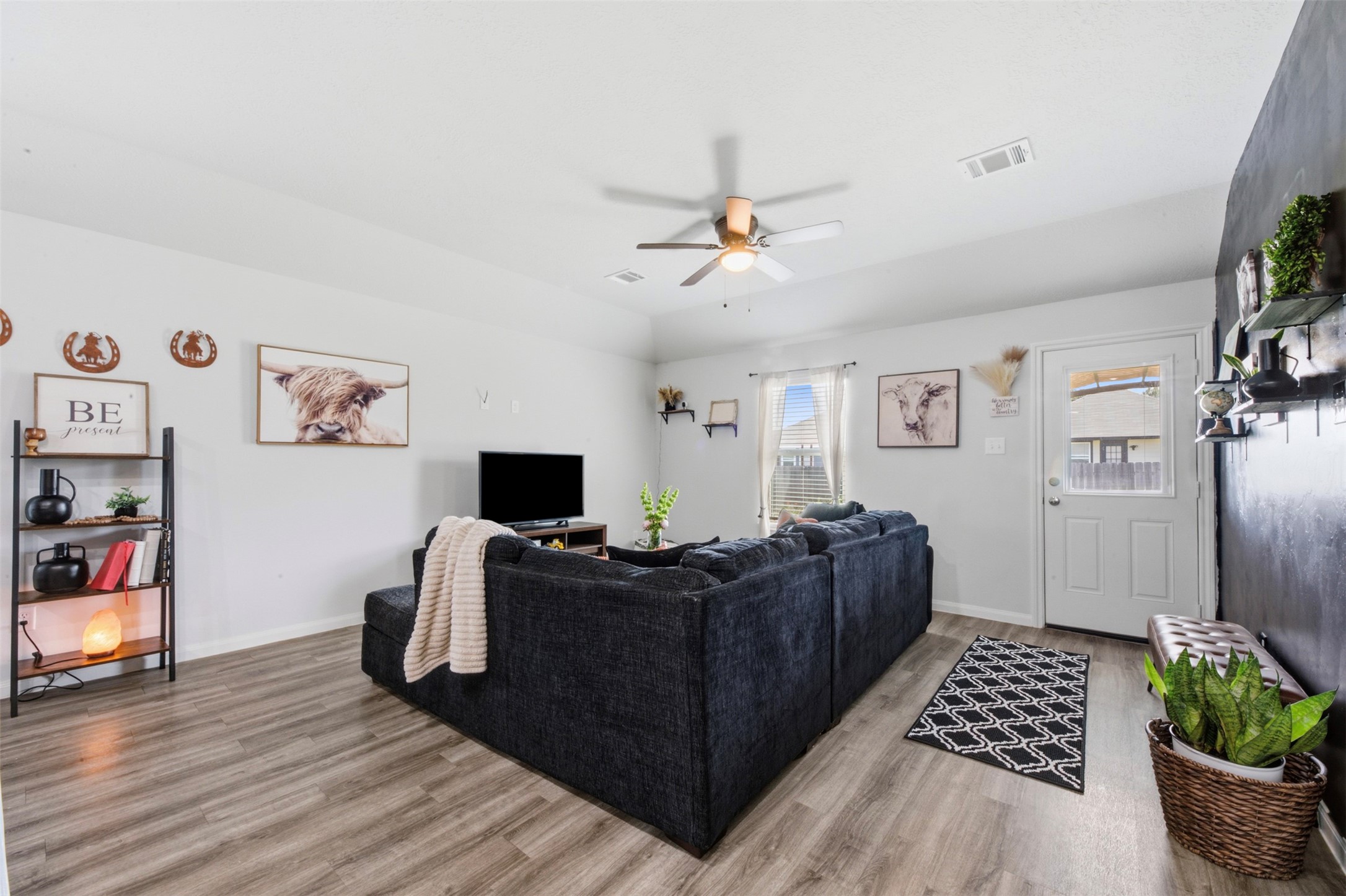 1523 22nd Street Hempstead, TX 77445 - Photo 11 of 26 Additional view of the spacious living room showcasing the open layout, natural light, and comfortable flow into the adjoining spaces.