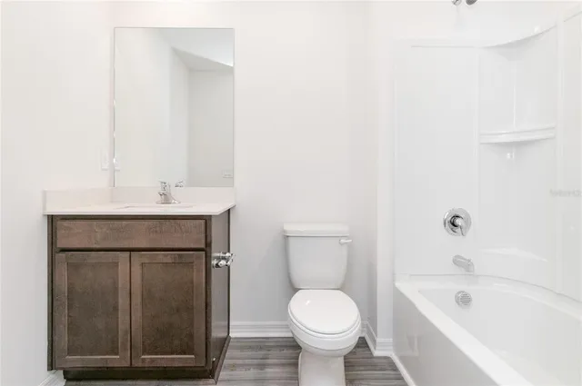 a bathroom with a sink a toilet and bathtub