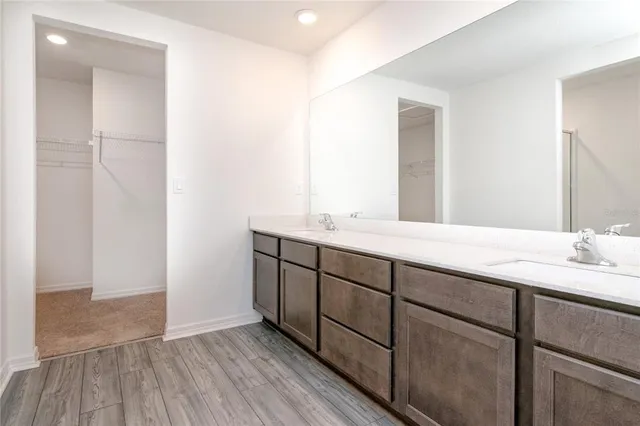 a bathroom with a double vanity sink and mirror