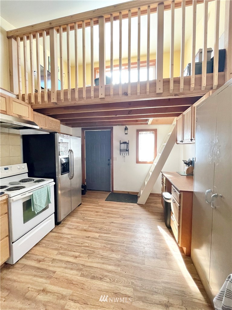 179 Tonasket Airport Road Tonasket, WA 98855 - Photo 11 of 31 a kitchen with a stove and a wooden floor