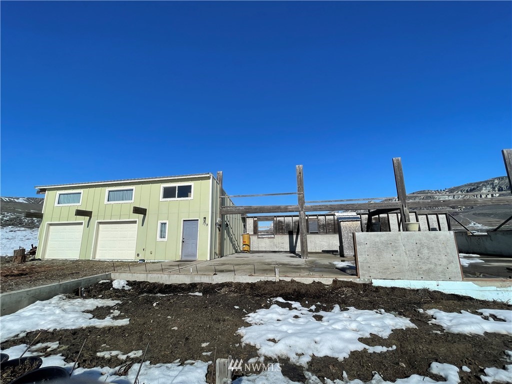 179 Tonasket Airport Road Tonasket, WA 98855 - Photo 2 of 31 a front view of a building with a yard