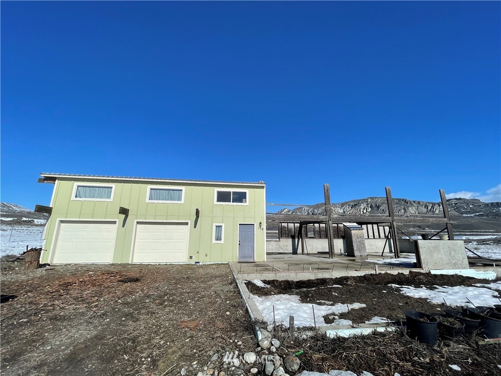 179 Tonasket Airport Road Tonasket, WA 98855 - Photo 3 of 31 a front view of a house with a yard