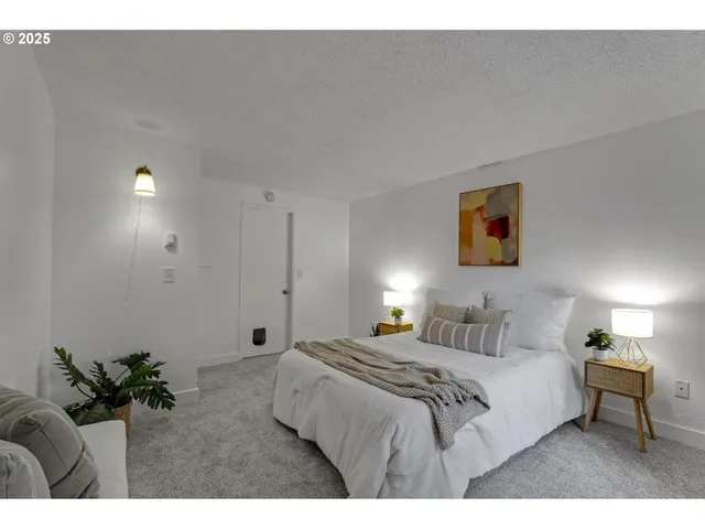 a bedroom with a bed and a painting on the wall