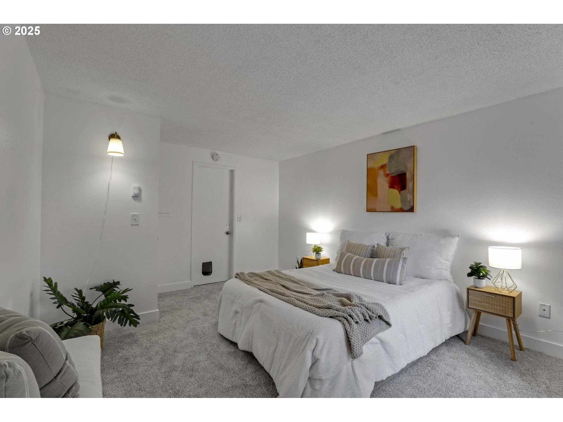 5488 Southwest Alger Avenue, Unit I7 Beaverton, OR 97005 - Photo 11 of 16 a bedroom with a bed and a painting on the wall