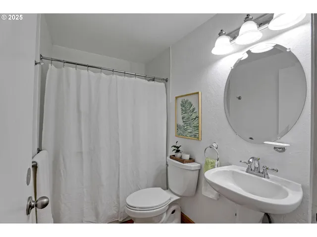 a bathroom with a sink toilet and a mirror