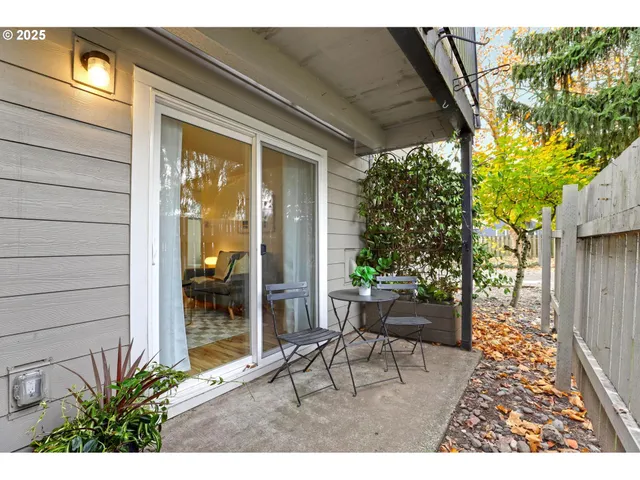 a view of a porch with chairs and potted plants