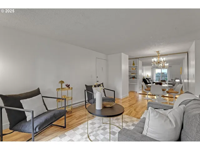 a living room with furniture and a dining table