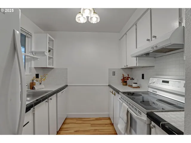 a kitchen with stainless steel appliances a sink stove and cabinets