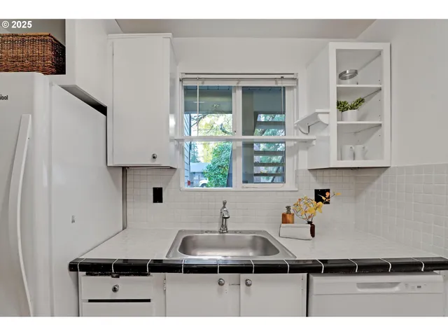 a kitchen with a sink and a refrigerator