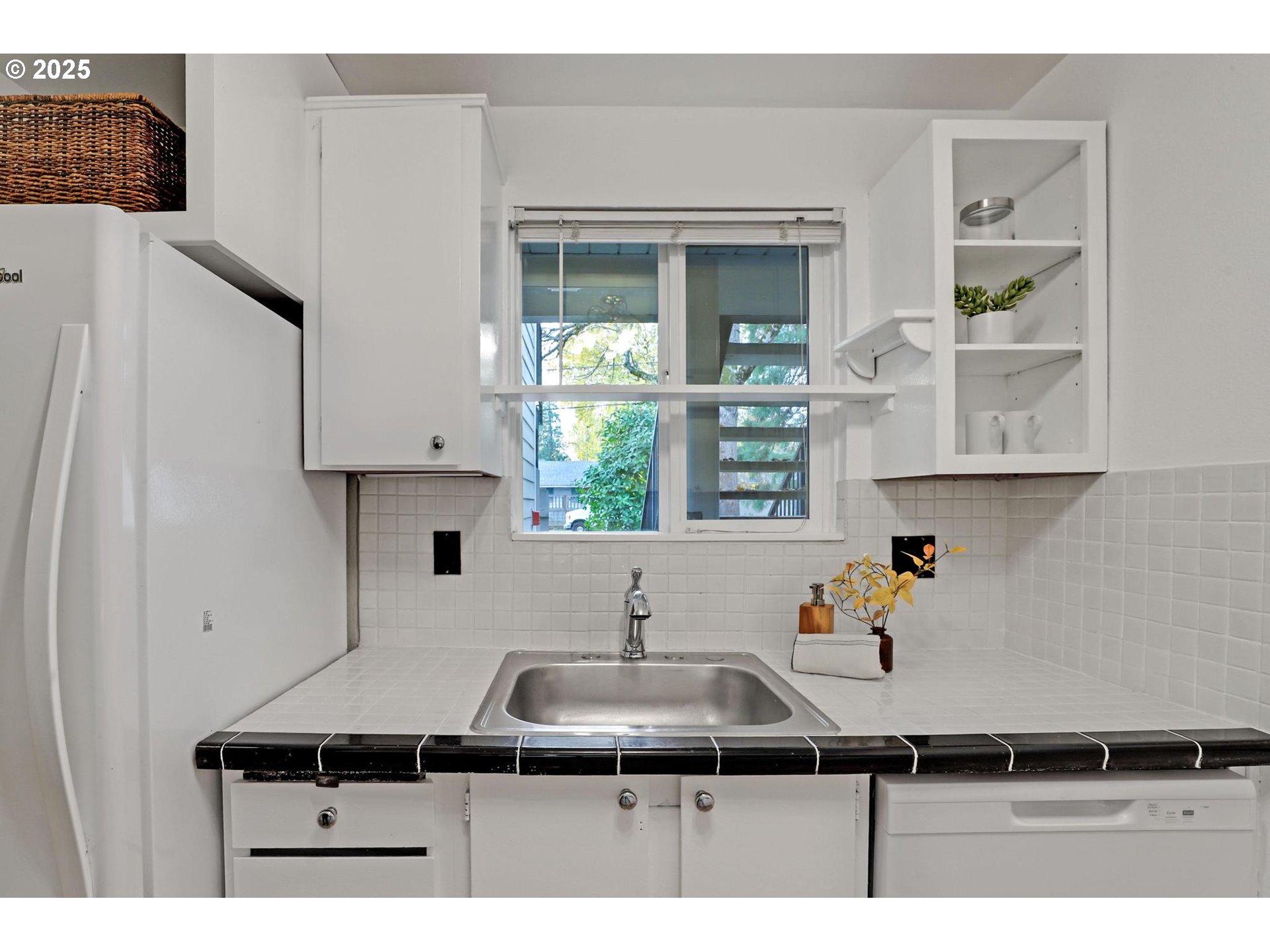 5488 Southwest Alger Avenue, Unit I7 Beaverton, OR 97005 - Photo 8 of 16 a kitchen with a sink and a refrigerator