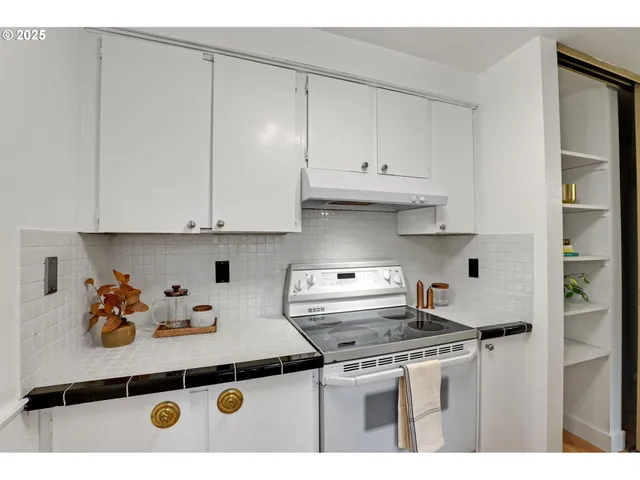 a kitchen with stainless steel appliances a stove a refrigerator and cabinets