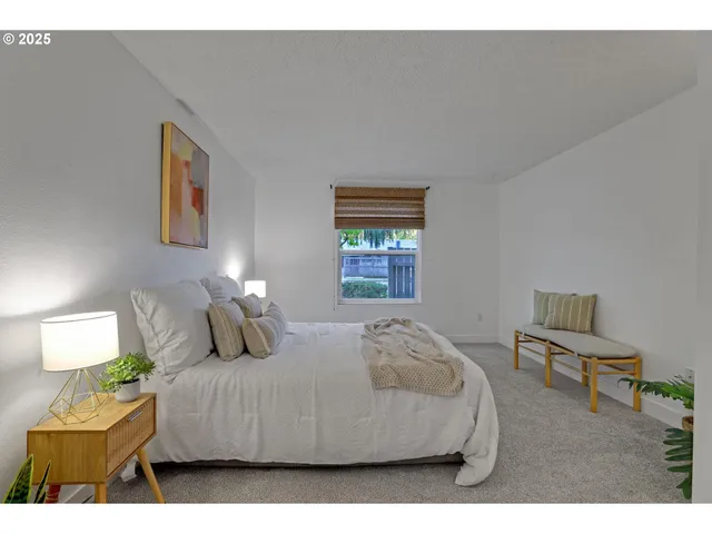 a bedroom with a bed and a window