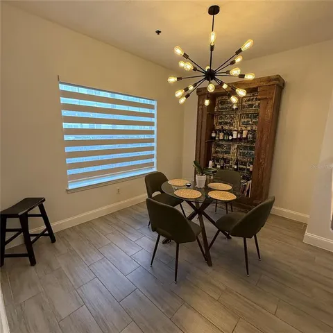 a dining room with furniture and wooden floor