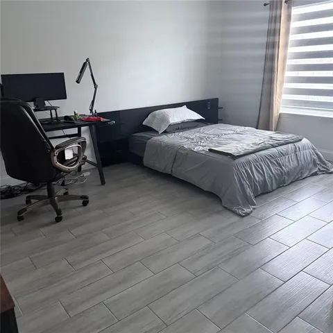 a bedroom with a bed a desk and chair