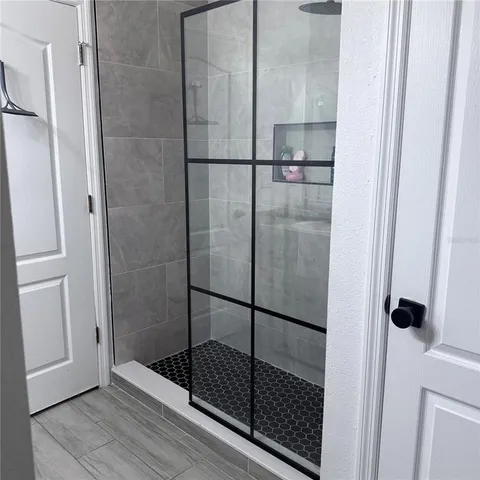 a bathroom with a glass shower door