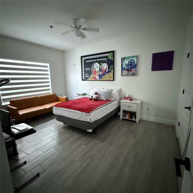 4833 Cypress Woods Drive, Unit 4112 Orlando, FL 32811 - Photo 7 of 10 a bedroom with bed and a window