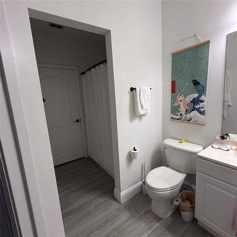 4833 Cypress Woods Drive, Unit 4112 Orlando, FL 32811 - Photo 8 of 10 a bathroom with a toilet and a shower