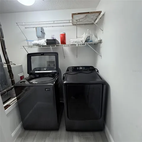 a utility room with closet dryer and washer