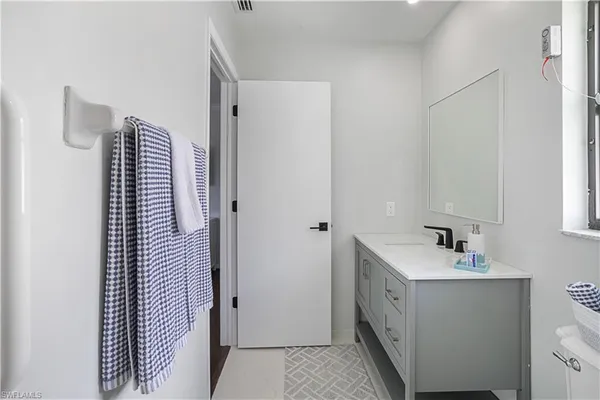 a bathroom with a sink and mirror