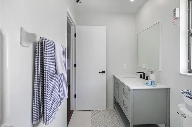 a bathroom with a sink and mirror