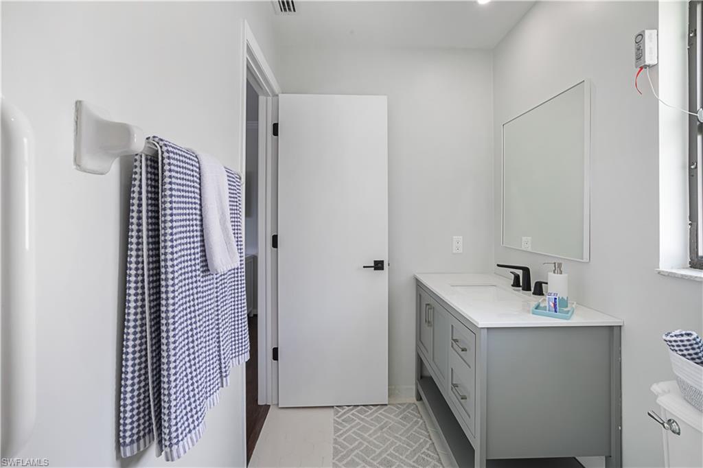 682 95th Avenue North Naples, FL 34108 - Photo 14 of 30 a bathroom with a sink and mirror