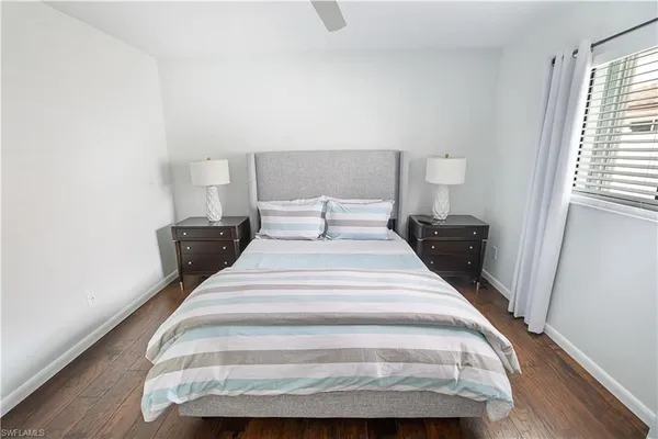 a bed with a white comforter and pillows