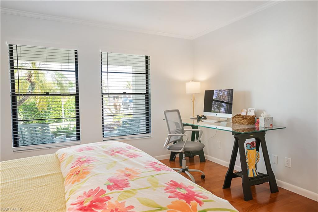 682 95th Avenue North Naples, FL 34108 - Photo 18 of 30 a bed room with a bed window and a table