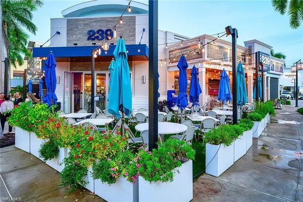 a view of a house with potted plants