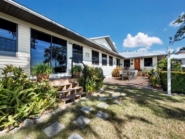 a view of a roof deck with couches and wooden floor