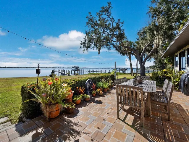 a view of a patio with table and chairs and potted plants