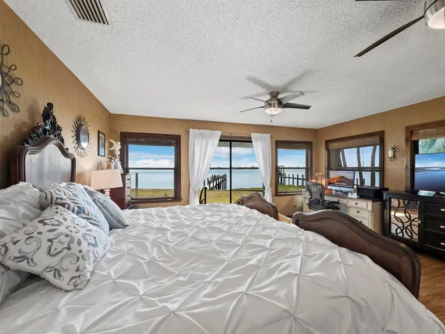 a bathroom with a toilet a double vanity sink and a mirror