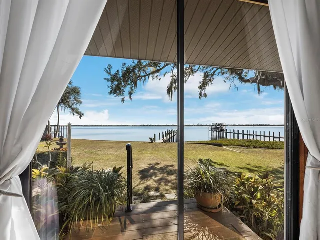 a bedroom with a bed mirror and a window