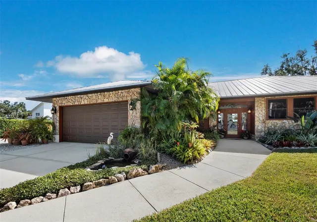a front view of a house with a garden