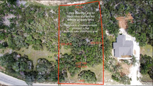 an aerial view of residential house with outdoor space and trees all around