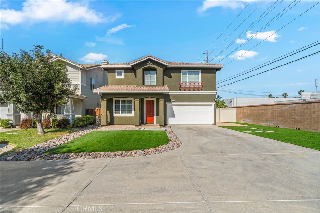 11141 Gardenhurst Court Riverside, CA 92505 - Photo 3 of 65 a front view of a house with a yard and garage