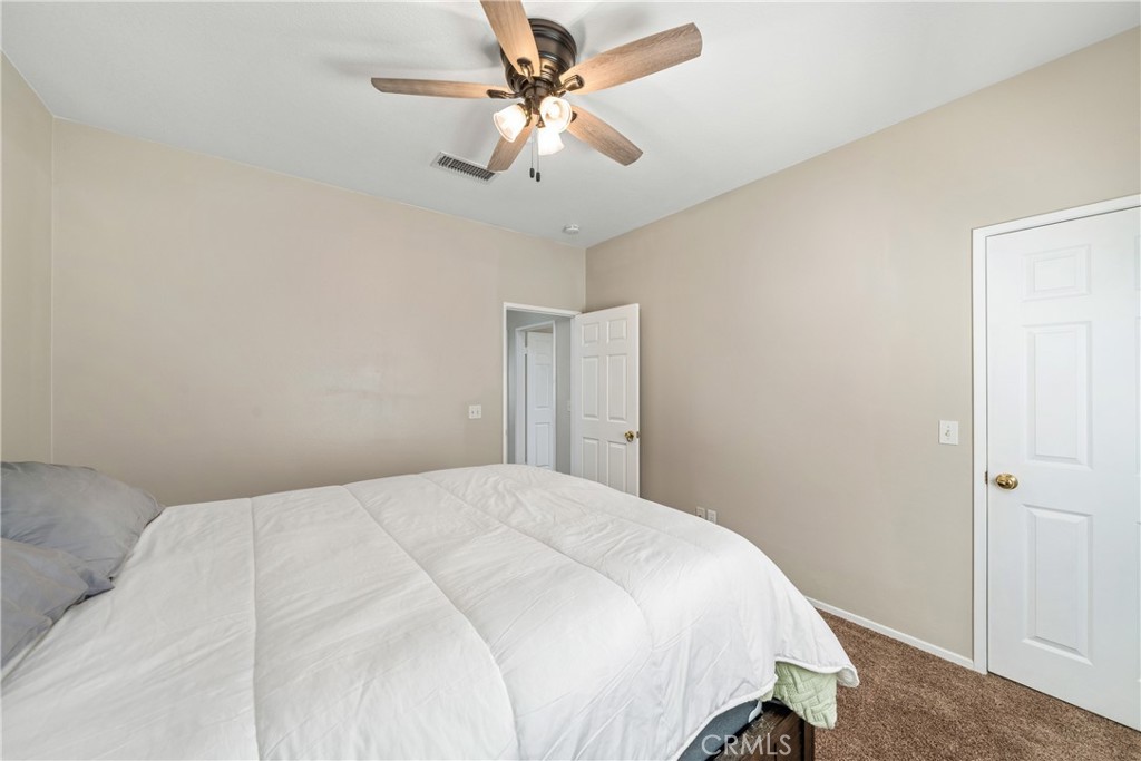 11141 Gardenhurst Court Riverside, CA 92505 - Photo 33 of 65 a bedroom with a bed and a ceiling fan