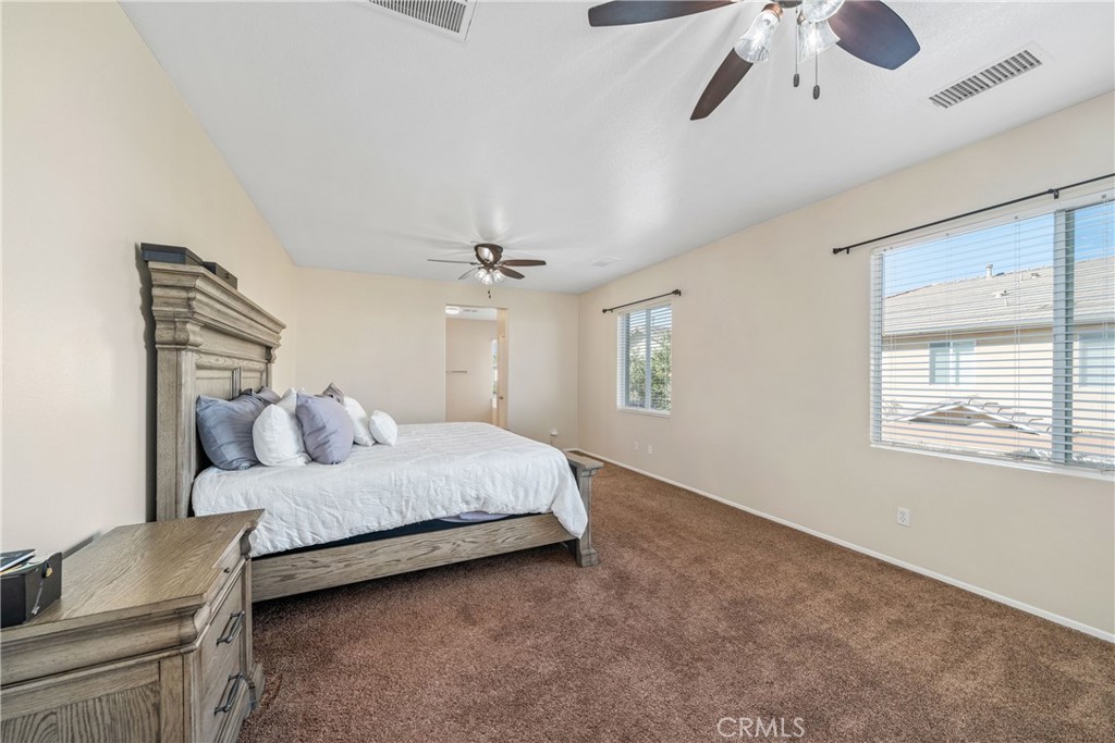 11141 Gardenhurst Court Riverside, CA 92505 - Photo 36 of 65 a bedroom with a bed chandelier and a window