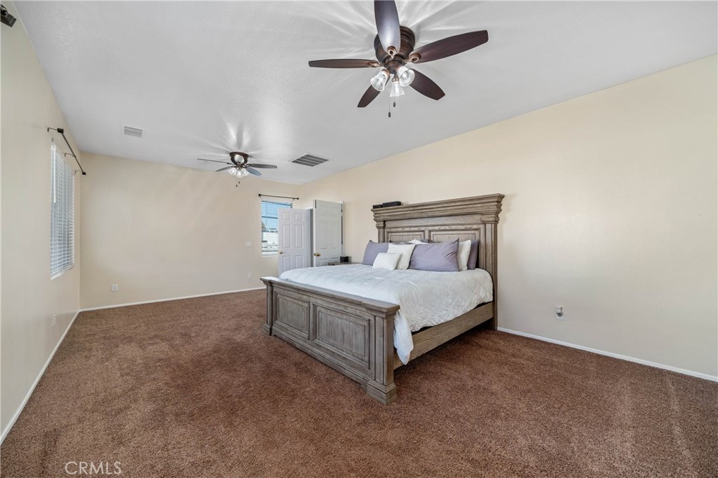 11141 Gardenhurst Court Riverside, CA 92505 - Photo 38 of 65 a bedroom with a bed and a ceiling fan