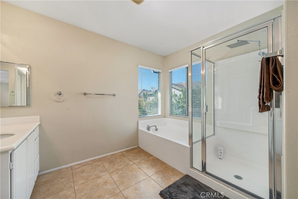 11141 Gardenhurst Court Riverside, CA 92505 - Photo 42 of 65 a bathroom with a bathtub and a shower