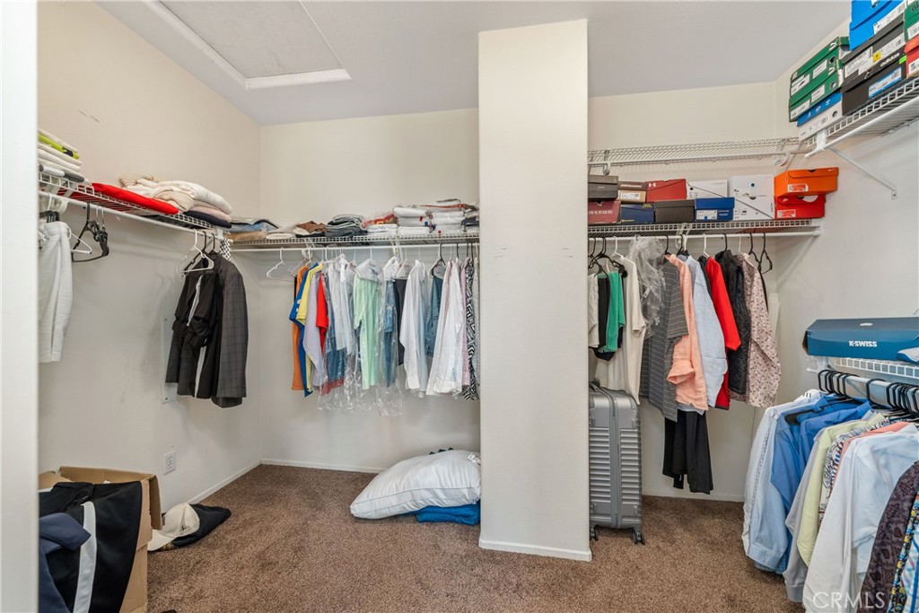 11141 Gardenhurst Court Riverside, CA 92505 - Photo 46 of 65 a view of walk in closet with clothes and shoes