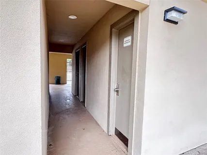 a view of a hallway with wooden shelves