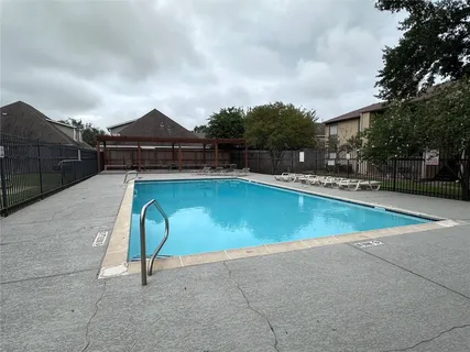 a view of a swimming pool with a yard