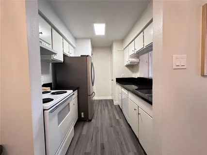 a kitchen with stainless steel appliances a stove microwave and a refrigerator