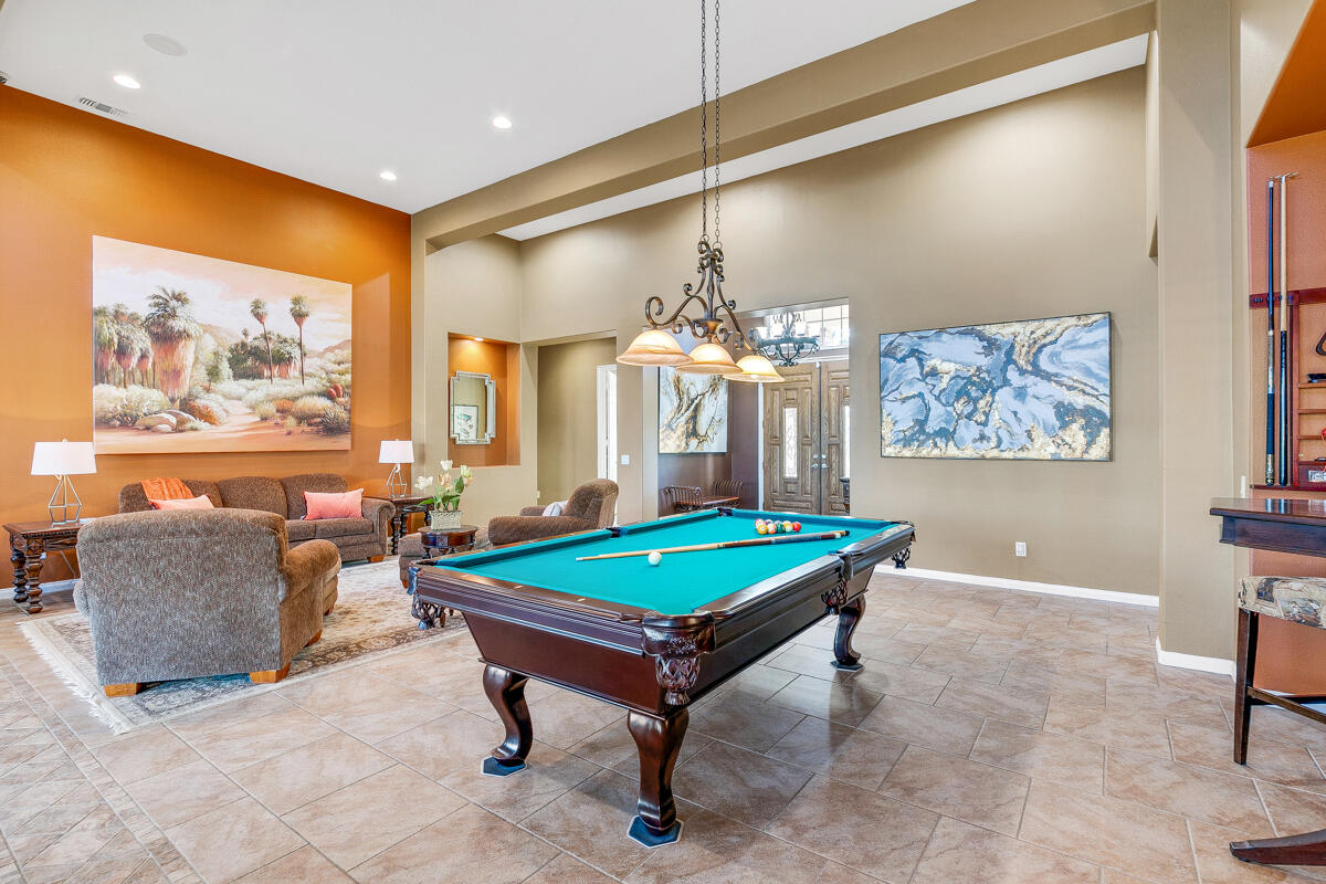 49130 Escalante Street Indio, CA 92201 - Photo 13 of 99 a living room with furniture a chandelier and a pool table