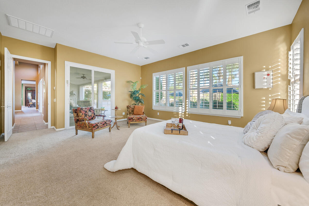 49130 Escalante Street Indio, CA 92201 - Photo 29 of 99 a spacious bedroom with a bed and glass windows