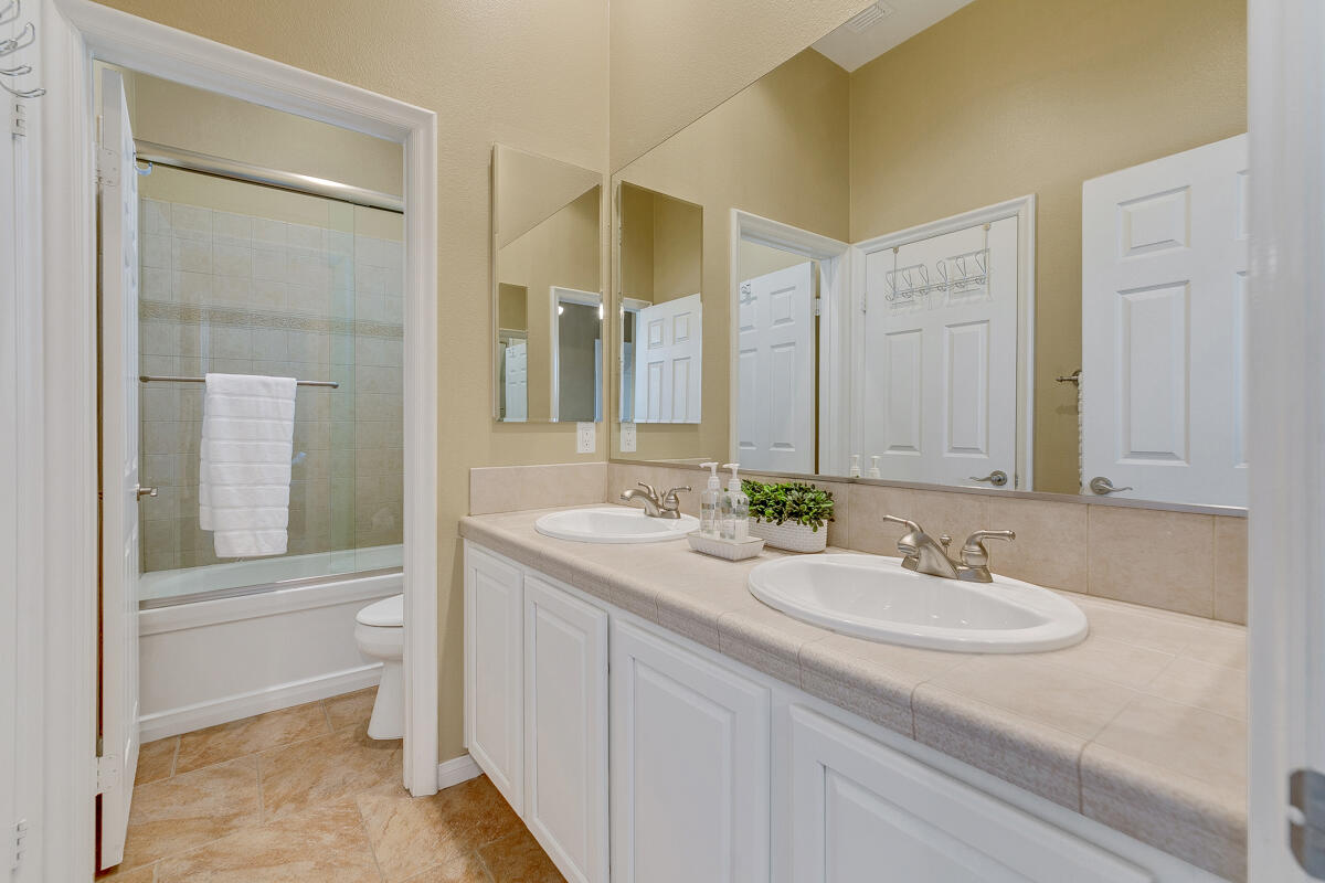 49130 Escalante Street Indio, CA 92201 - Photo 35 of 99 a bathroom with a granite countertop sink and a mirror