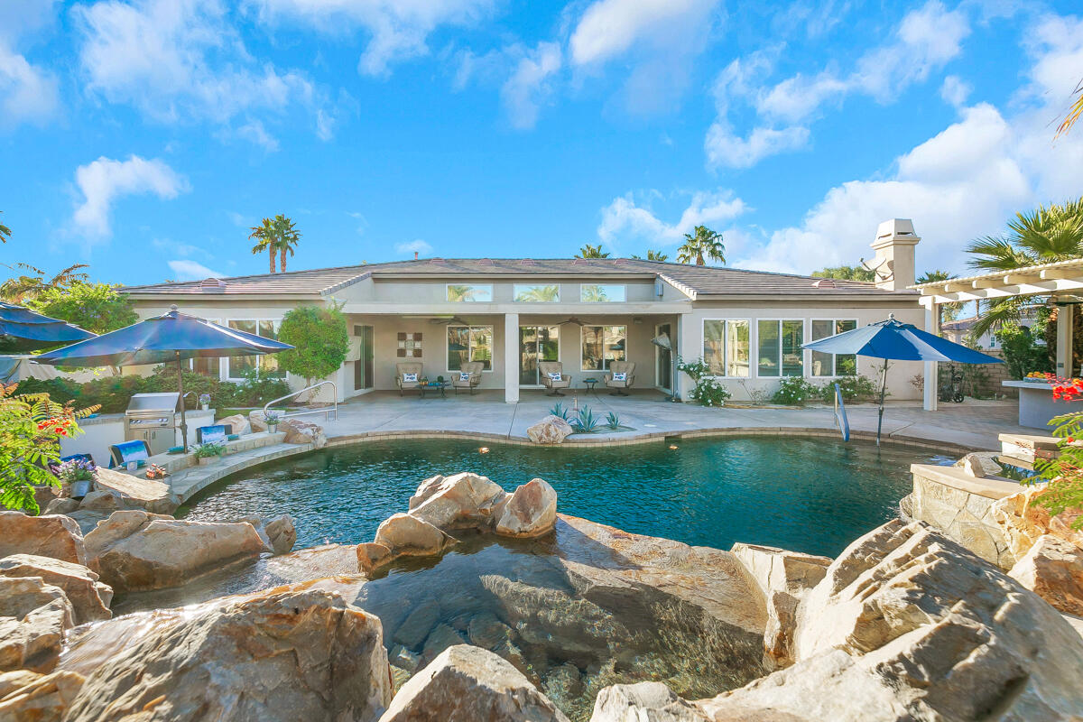 49130 Escalante Street Indio, CA 92201 - Photo 44 of 99 a view of a house with swimming pool and a yard