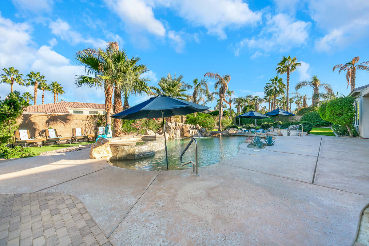 49130 Escalante Street Indio, CA 92201 - Photo 48 of 99 a view of a street with a table and chairs under an umbrella